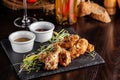 The concept of Italian cuisine. Snack to beer. Glazed chicken legs and chicken wings, breaded. Serving dishes in the restaurant Royalty Free Stock Photo