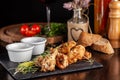 The concept of Italian cuisine. Snack to beer. Glazed chicken legs and chicken wings, breaded. Serving dishes in the restaurant Royalty Free Stock Photo