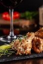 The concept of Italian cuisine. Snack to beer. Glazed chicken legs and chicken wings, breaded. Serving dishes in the restaurant Royalty Free Stock Photo