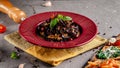 The concept of Italian cuisine. Sweet Pasta papardelle with walnuts nuts and candied fruit. Cocoa black paste. Serving dishes Royalty Free Stock Photo