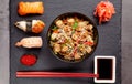 Concept of Japanese cuisine. Japanese lunch of noodles, sushi with shrimp, red caviar, eel, tuna. Soy sauce and chinese sticks