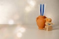 Concept of of jewish religion holiday hanukkah with wooden spinning top toys dreidels, small clay jar with blue and white