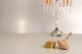 concept of jewish religious holiday hanukkah with wooden spinning top toy & x28;dreidel& x29; and chocolate coins Royalty Free Stock Photo
