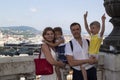 Concept of a joyful journey with children. Happy parents and their children smiling look at the camera and standing on the Royalty Free Stock Photo