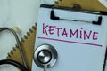 Concept of Ketamine write on paperwork with stethoscope isolated on Wooden Table