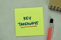 Concept of Key Takeaways write on sticky notes isolated on Wooden Table Royalty Free Stock Photo
