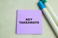Concept of Key Takeaways write on sticky notes isolated on Wooden Table