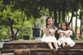 Concept kids and gadgets. Two little girls siblings sisters look at the phone. They hold a smartphone watch videos, learn, play