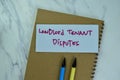 Concept of Landlord Tenant Disputes write on sticky notes isolated on Wooden Table