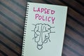 Concept of Lapsed Policy write on a book isolated on Wooden Table Royalty Free Stock Photo