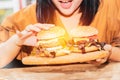 Asian women love to eat hamburgers that are high in fat and cholesterol. Royalty Free Stock Photo
