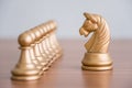 Concept of leadership, think different and recruitment employee. Knight chess leading pawns on wooden table. Leadership skills