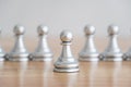 Concept of leadership, think different and recruitment employee. Pawn chess leading others on wooden table. Leadership skills