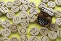 Concept of learning english, searching for word, and information. English alphabet letter and miniature typewriter on yellow backg