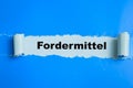 Concept of Learning language - German. Fordermittel it means funding written on torn paper Royalty Free Stock Photo