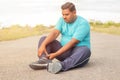 Concept of leg tendon injury of fat man - obese person holding leg suffering muscle pain - overweight man fitness