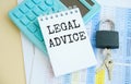 Concept Legal Advice message on notebook with glasses, pencil and coffee cup on table Royalty Free Stock Photo