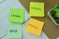 Concept of Legal, Moral, Fair, Ethical write on sticky notes isolated on Wooden Table Royalty Free Stock Photo