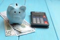 The concept of lending. Money, calculator, piggy bank.