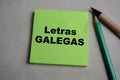 Concept of Letras Galegas write on sticky notes isolated on Wooden Table Royalty Free Stock Photo