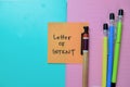 Concept of Letter of Intent write on sticky notes isolated on Wooden Table