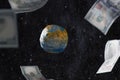 The concept of levitating dollar bills around the layout of the planet Earth, against the background of space. Money rules the