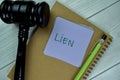 Concept of Lien write on sticky notes with gavel isolated on Wooden Table Royalty Free Stock Photo