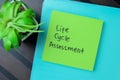 Concept of Life Cycle Assessment write on sticky notes isolated on Wooden Table