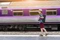 Concept life style holidays travel or journey : Young Asian backpacker man is walking to take a train at the station Royalty Free Stock Photo