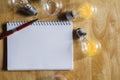 concept light bulb and notebook with pen on wood Royalty Free Stock Photo