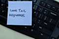 Concept of Long Tail Keywords write on sticky notes isolated on Wooden Table Royalty Free Stock Photo