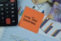 Concept of Long Term Investment write on sticky notes isolated on Wooden Table