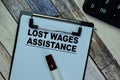 Concept of Lost Wages Assistance write on paperwork isolated on Wooden Table Royalty Free Stock Photo