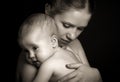 Concept for love and family. mother hugging baby tenderly in mon Royalty Free Stock Photo