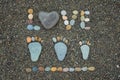 Family steps and word love made from stones on sandy beach. Royalty Free Stock Photo