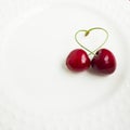 The concept of love - heart from berries of a sweet cherry.Isolated cherry. Heart shape from two cherries isolated white Royalty Free Stock Photo