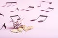 The concept of love for music. Two paper hearts, dry flowers and notes around on a pink background Royalty Free Stock Photo