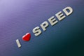 Concept of love of speed, fast cars and racing. Letters on carbon fibre background Royalty Free Stock Photo