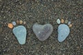 Steps of man, woman and heart made from stones on sandy beach. Royalty Free Stock Photo