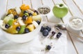 The concept of low-calorie delicious desserts. Fruit salad bowl with colorful fruits. Healthy natural organic food Royalty Free Stock Photo