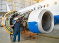 Concept maintenance of aircraft. Replacing the engine on the airplane, working people tap. Royalty Free Stock Photo