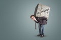 Man carrying a large stone with the word `Mortgage` printed on it Royalty Free Stock Photo