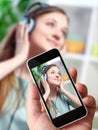 Man taking a picture of his girlfriend with a Smartphone Royalty Free Stock Photo