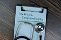 Concept of Medical Confidentiality write on a paperwork with stethoscope isolated on Wooden Table