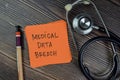 Concept of Medical Data Breach write on sticky notes isolated on Wooden Table Royalty Free Stock Photo