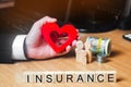 Concept medical insurance, family, children, life insurance. heart in the hands of a businessman. dollars, coins and family.