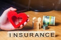 Concept medical insurance, family, children, life insurance. heart in the hands of a businessman. dollars, coins and family.