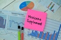 Concept of Medicare Supplement write on sticky notes with statistics isolated on Wooden Table