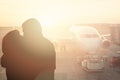 The concept of meeting or parting two people. Couple kiss on the background of the aircraft Royalty Free Stock Photo