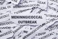 The concept of a meningococcal outbreak on a background of torn pieces of paper